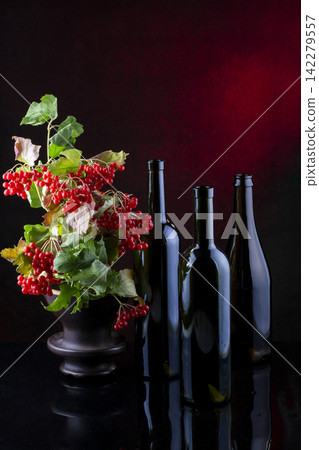 Still life with glass bottles and red viburnum Still life with glass bottles and red viburnum 142279557