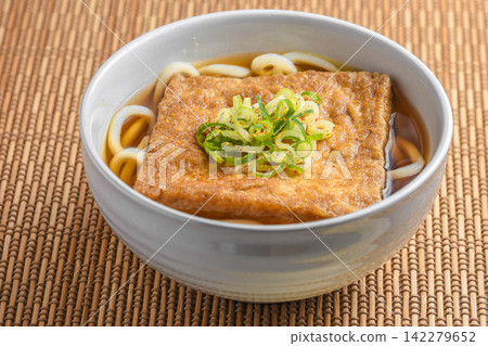 Kitsune udon with a large piece of fried tofu Kitsune udon with a large piece of fried tofu 142279652