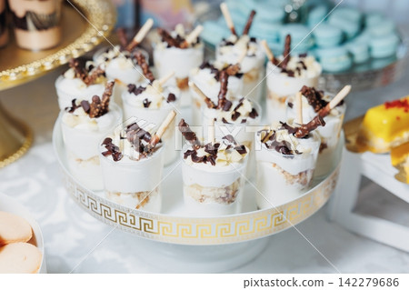 Elegant dessert cups topped with chocolate shavings Elegant dessert cups topped with chocolate shavings 142279686