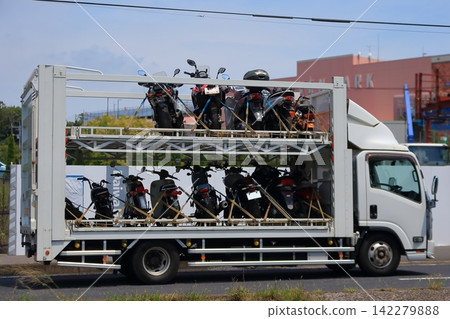Truck transporting motorcycles Truck transporting motorcycles 142279888