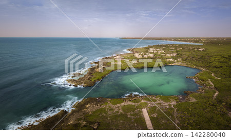 Panorama of beach with a stunning cliff overlooking the Caribbean Sea Panorama of beach with a stunning cliff overlooking the Caribbean Sea 142280040