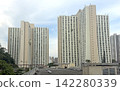 Hong Kong residential apartment buildings under a cloudy sky in an urban setting Hong Kong residential apartment buildings under a cloudy sky in an urban setting 142280339