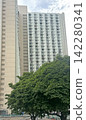 Hong Kong residential building with many windows against a cloudy sky Hong Kong residential building with many windows against a cloudy sky 142280341