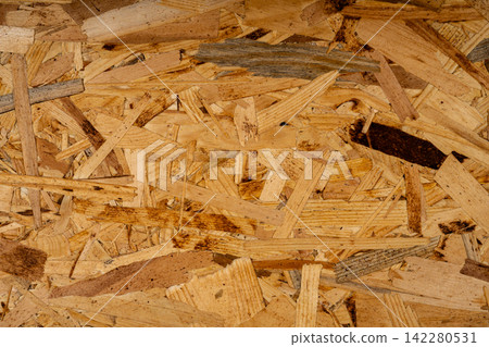Brown abstract background with chaotic structure of wood elements of construction material close-up. Brown abstract background with chaotic structure of wood elements of construction material close-up. 142280531