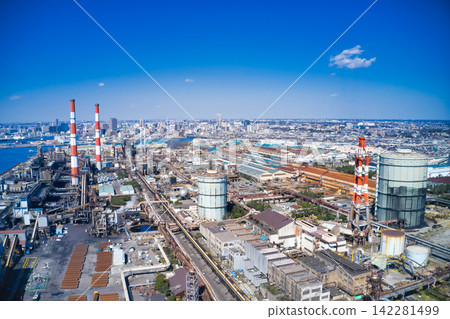 Drone aerial photography of an industrial area. Factories, manufacturing, industry, chimneys, energy, production, petrochemicals, refineries, iron and steel industry, power plants. Drone aerial photography of an industrial area. Factories, manufacturing, industry, chimneys, energy, production, petrochemicals, refineries, iron and steel industry, power plants. 142281499