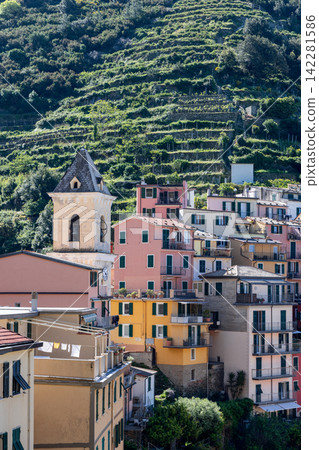 San Lorenzo church in Manarola, Italy from telephoto village perspective San Lorenzo church in Manarola, Italy from telephoto village perspective 142281586
