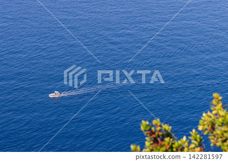 Motorboat, moving vessel surrounded by negative space, long telephoto downward perspective Motorboat, moving vessel surrounded by negative space, long telephoto downward perspective 142281597