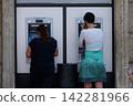 Girl withdrawing money from an ATM machine 142281966