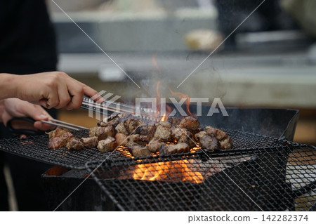 Flipping Diced Pork On Grill Flipping Diced Pork On Grill 142282374