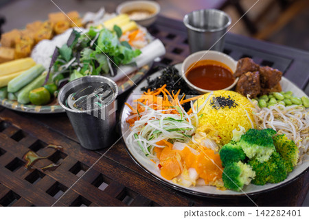 healthy vegetarian rice bowl with fresh vegetables broccoli sprouts and vegan meal, colorful vegan healthy food plate with organic rice vegetables and plant based cuisine healthy vegetarian rice bowl with fresh vegetables broccoli sprouts and vegan meal, colorful vegan healthy food plate with organic rice vegetables and plant based cuisine 142282401