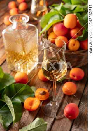 Apricot liqueur or grappa and fresh apricots. Apricot liqueur or grappa and fresh apricots. 142282811