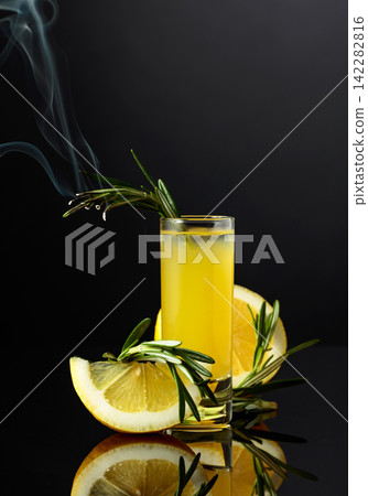 Traditional liqueur Limoncello on the black background. Traditional liqueur Limoncello on the black background. 142282816