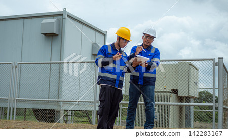 Two Asian Male Electrical Engineers Inspecting Outdoor Power Substation Two Asian Male Electrical Engineers Inspecting Outdoor Power Substation 142283167