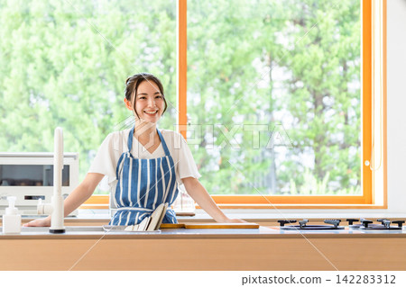 A woman in the kitchen. Cooking, housework, smile, nutritionist, cafe, meal, chef, housekeeping service, recipe, menu, housewife A woman in the kitchen. Cooking, housework, smile, nutritionist, cafe, meal, chef, housekeeping service, recipe, menu, housewife 142283312