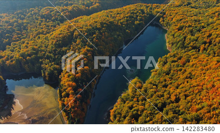 Biogradsko lake surrounded by mountains covered with bright autumn trees Biogradsko lake surrounded by mountains covered with bright autumn trees 142283480