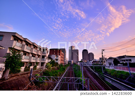 A view of the sunrise towards JR Ebisu Station from Shirokane Sandobashi Bridge in Shinagawa Ward, Tokyo. A view of the sunrise towards JR Ebisu Station from Shirokane Sandobashi Bridge in Shinagawa Ward, Tokyo. 142283600