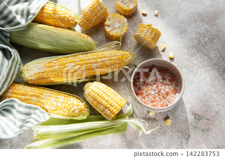 Fresh sweet corn cobs with salt on table Fresh sweet corn cobs with salt on table 142283753