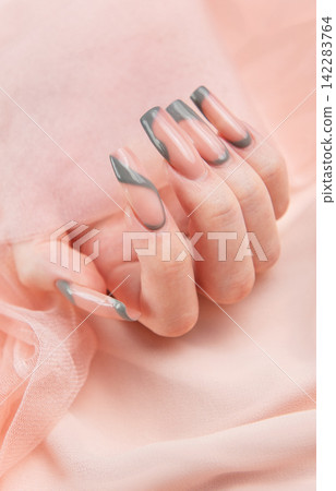 Female hand showing long square marble design nails Female hand showing long square marble design nails 142283764