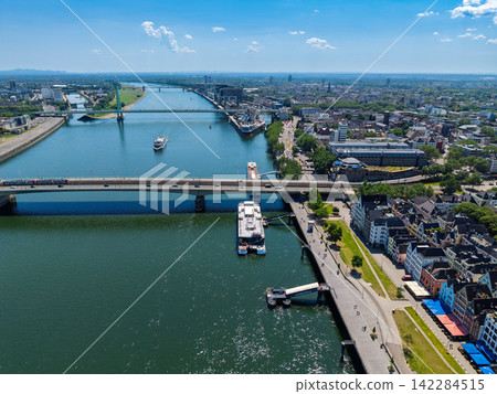 High angle wide horizontal aerial drone photograph of Rhine river, Deutzer Bridge, Severins Bridge, Kranhauser, and city skyline in Cologne, North Rhine-Westphalia Germany Central Europe on sunny day 142284515