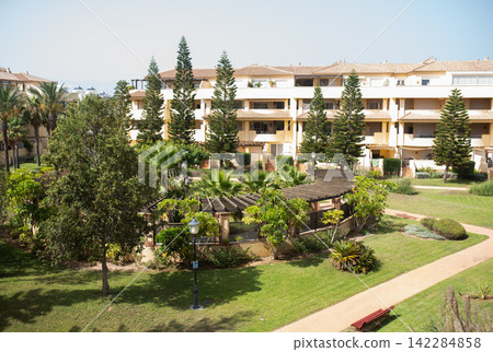 Beautiful Mediterranean style residential complex with palm trees and gardens Beautiful Mediterranean style residential complex with palm trees and gardens 142284858