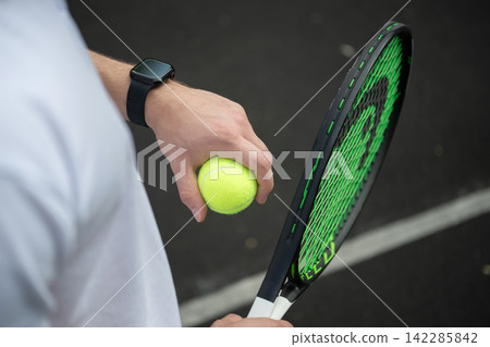 Tennis player with smartwatch tracking outdoor workout Tennis player with smartwatch tracking outdoor workout 142285842
