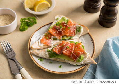 Salmon toast with avocado and cream cheese, breakfast, healthy food Salmon toast with avocado and cream cheese, breakfast, healthy food 142286095