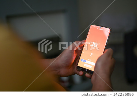 Smartphone connecting to heating system. Remote home control system on a smartphone. smart home Smartphone connecting to heating system. Remote home control system on a smartphone. smart home 142286096