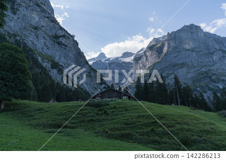 A mountain hut in the valley and a rocky peak A mountain hut in the valley and a rocky peak 142286213