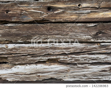 Weathered wood texture from an old wooden house 142286963