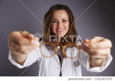 Eye Doctor Presenting Prescription Eyewear Frames Eye Doctor Presenting Prescription Eyewear Frames 142287203