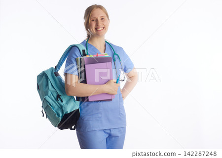 Smiling Nursing Student with Backpack and Textbooks Smiling Nursing Student with Backpack and Textbooks 142287248