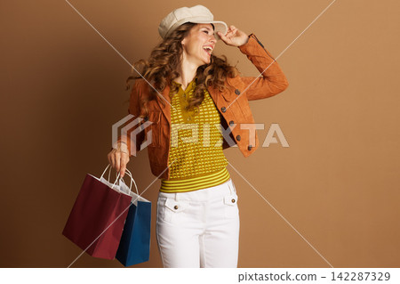 Cheerful Shopper Touching Her Autumn Cap 142287329