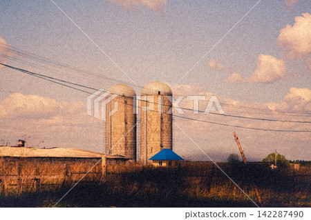 Cinematic vintage illustration of concrete silo towers on a rural farm Cinematic vintage illustration of concrete silo towers on a rural farm 142287490