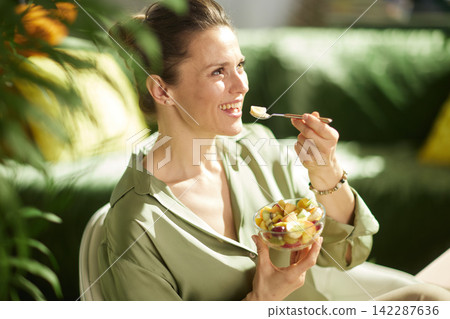 Close-Up of Woman Enjoying a Nutritious Fruit Snack 142287636