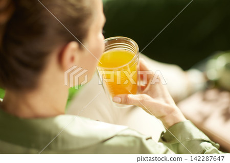 Woman Enjoying Fresh Orange Juice at Home Woman Enjoying Fresh Orange Juice at Home 142287647