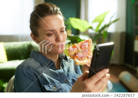 Relaxed Lunch Break with Pizza and Phone Relaxed Lunch Break with Pizza and Phone 142287657