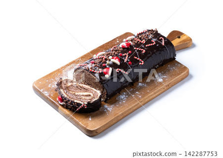 Christmas chocolate yule log cake with festive decorations Christmas chocolate yule log cake with festive decorations 142287753