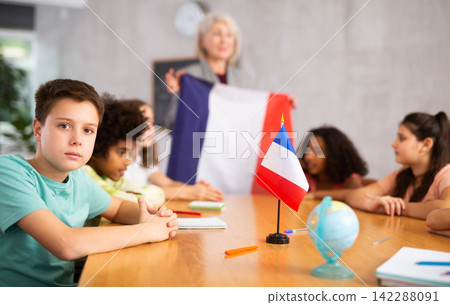 students listen to woman teacher who talks about France students listen to woman teacher who talks about France 142288091
