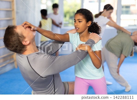 Self-defense training - girl delivers painful blow to the eyes of male trainer Self-defense training - girl delivers painful blow to the eyes of male trainer 142288111