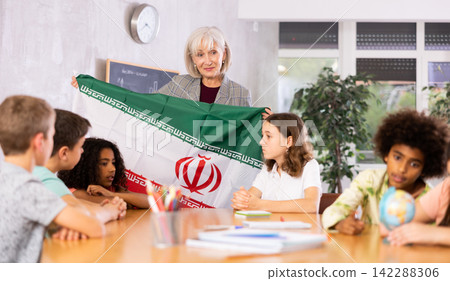 Female teacher tells pupils the history of Iran Female teacher tells pupils the history of Iran 142288306