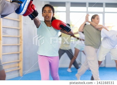 Coach and girl training boxing technique Coach and girl training boxing technique 142288531
