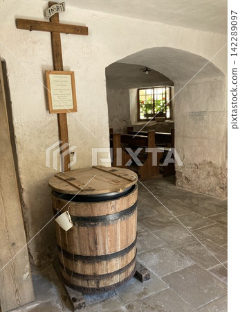Interior of a small traditional alpine chapel with benches and fresh water tank for travelers to use it free Interior of a small traditional alpine chapel with benches and fresh water tank for travelers to use it free 142289097