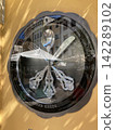 Unique creative wall clock made of metal spoons and forks on a house facade 142289102