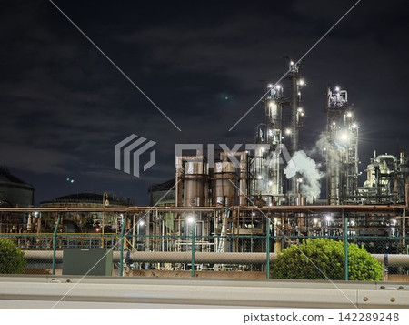 A gigantic plant and rising white smoke stand tall in the dark night of Chidori-cho, Kawasaki. A gigantic plant and rising white smoke stand tall in the dark night of Chidori-cho, Kawasaki. 142289248