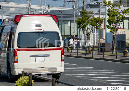 Rear view of an ambulance waiting on a street in an urban area. Rear view of an ambulance waiting on a street in an urban area. 142289446