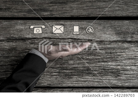 Contact us concept with a line of phone, web, mobile and mail symbols Contact us concept with a line of phone, web, mobile and mail symbols 142289703