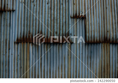A textured material of light blue corrugated iron roof with a rich, aged look due to rust. A textured material of light blue corrugated iron roof with a rich, aged look due to rust. 142290050