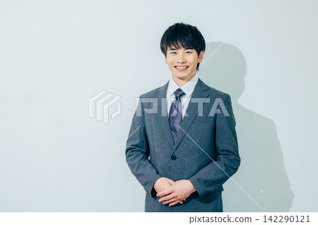 A young man looking at the camera and smiling A young man looking at the camera and smiling 142290121