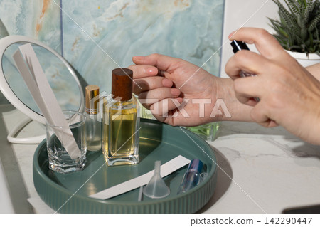 Fragrance Application at Vanity: Close-Up of Wrist Perfume Spritz for At-Home Beauty Fragrance Application at Vanity: Close-Up of Wrist Perfume Spritz for At-Home Beauty 142290447