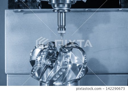 High precision parts cutting process on CNC milling machine using ball nose end mill in blue tone lighting High precision parts cutting process on CNC milling machine using ball nose end mill in blue tone lighting 142290673